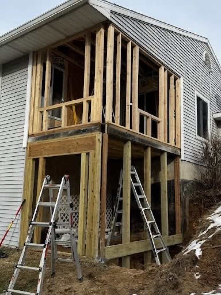 Second-story home addition mid-framing by OCD Building and Remodeling