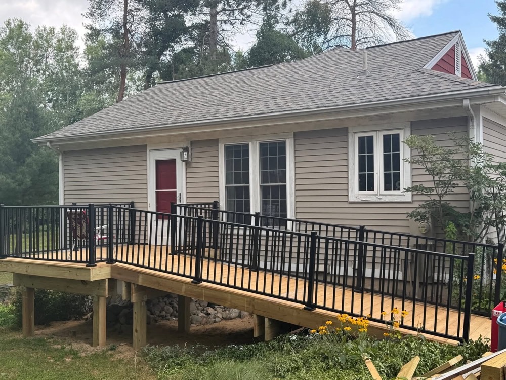 New wood deck with black aluminum railing built by OCD Building and Remodeling